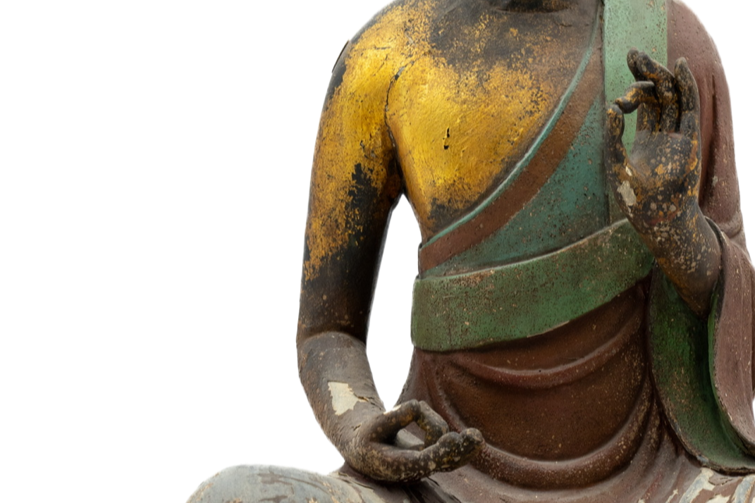 Statue of a seated Buddha figure on a white background